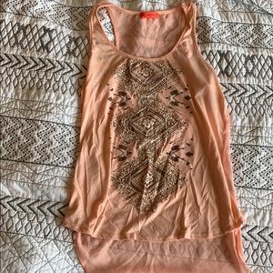 Cute tank top with sheer backing.